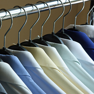 Dry Cleaned Shirts on Hangers on a Rack