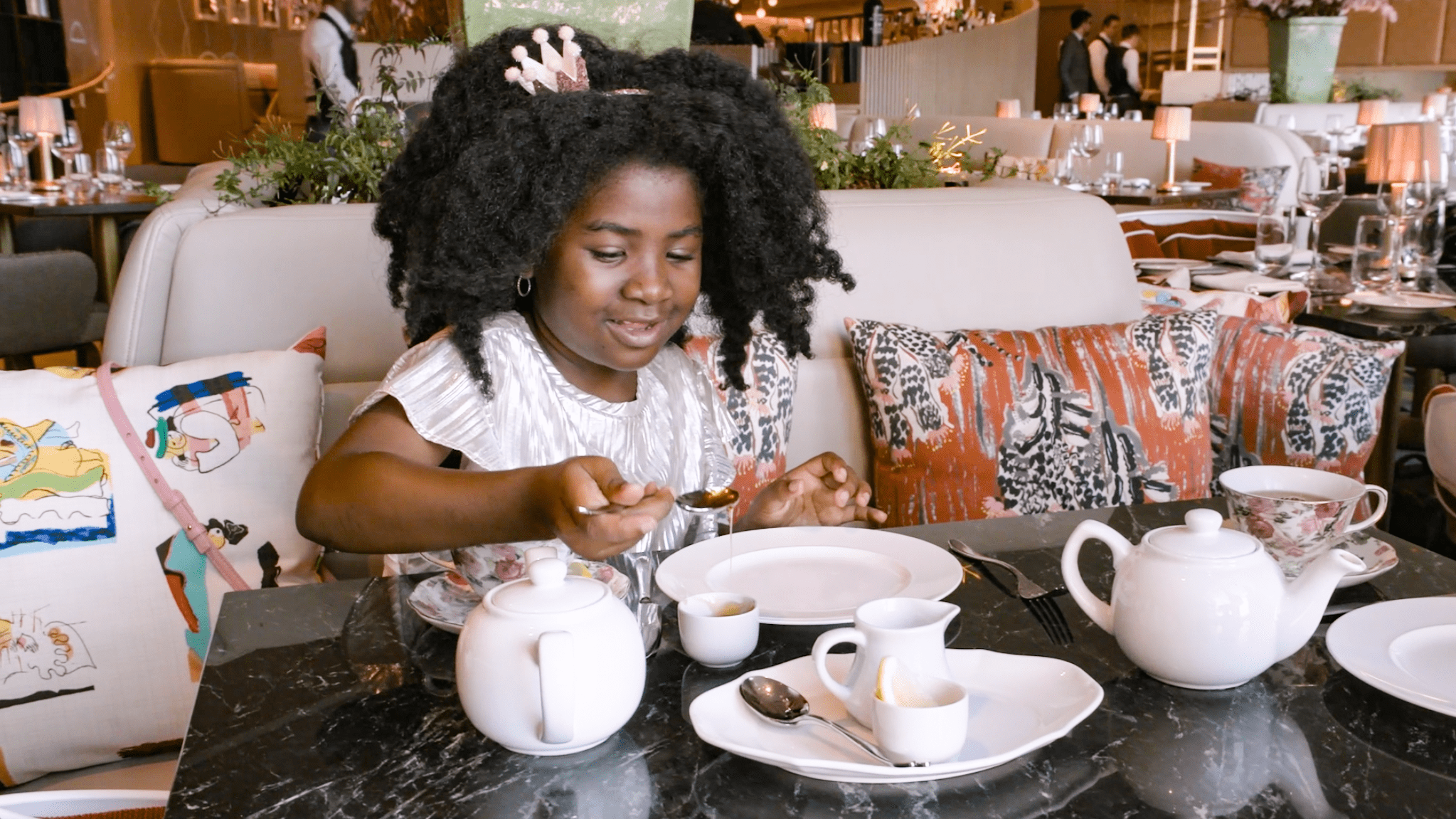 young girl having a tea party