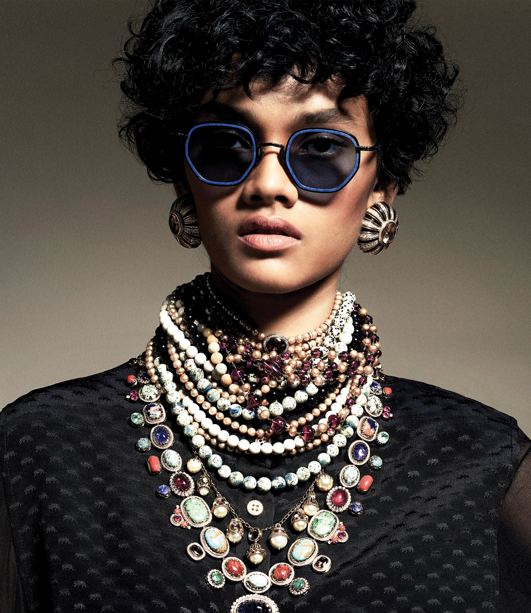 woman with sunglasses and jewellery