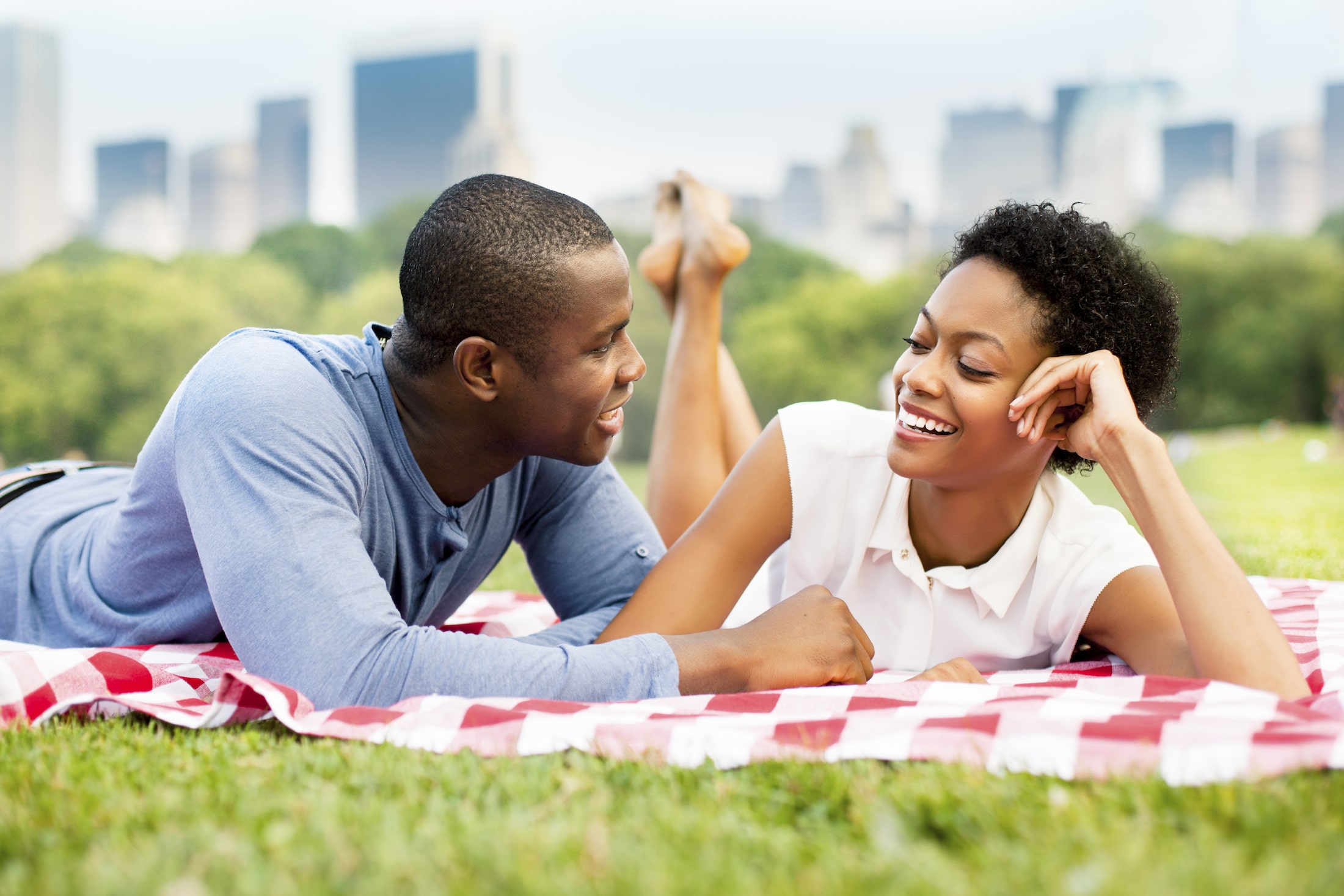 young couple laying on a blanket