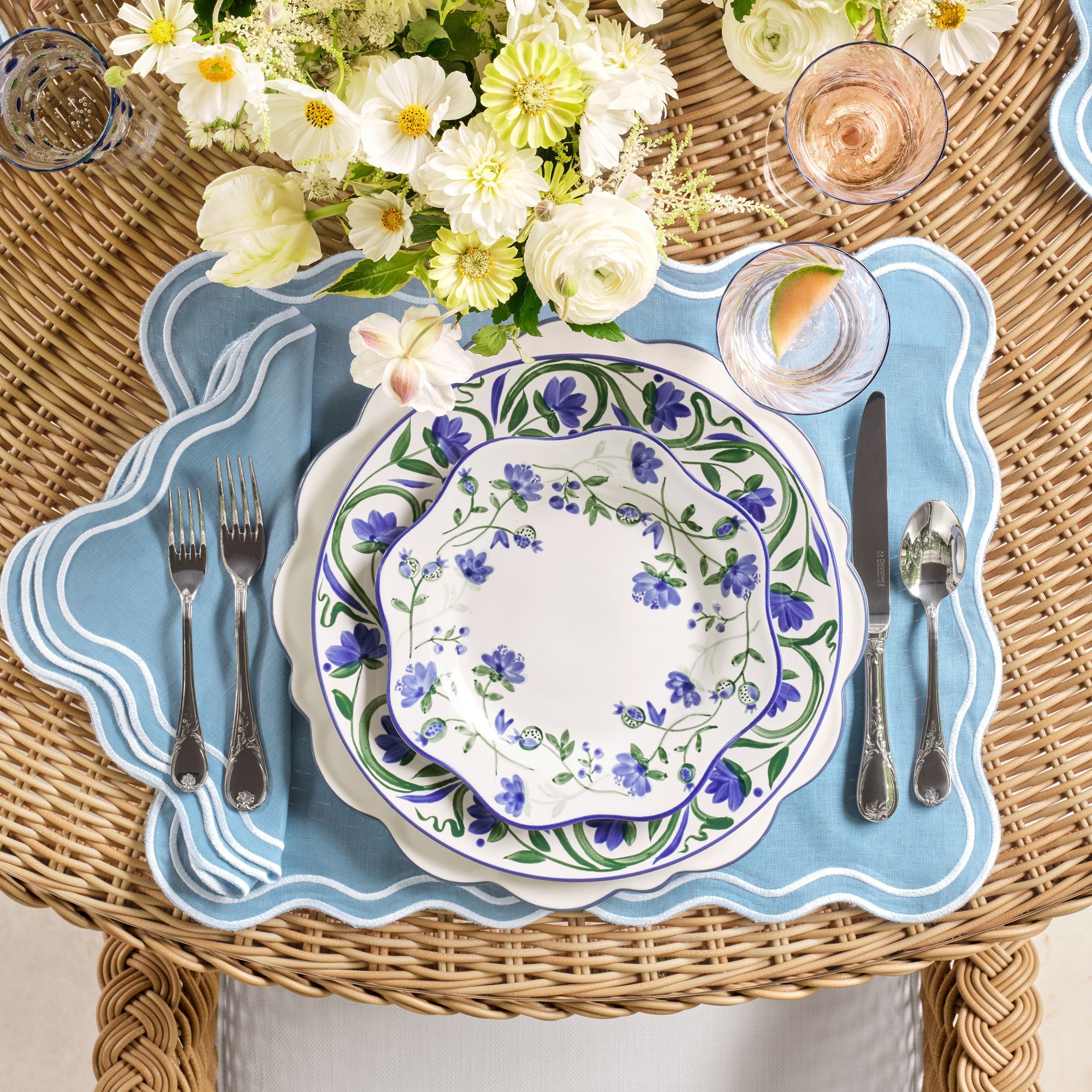 blue scalloped platter, white and yellow flowers